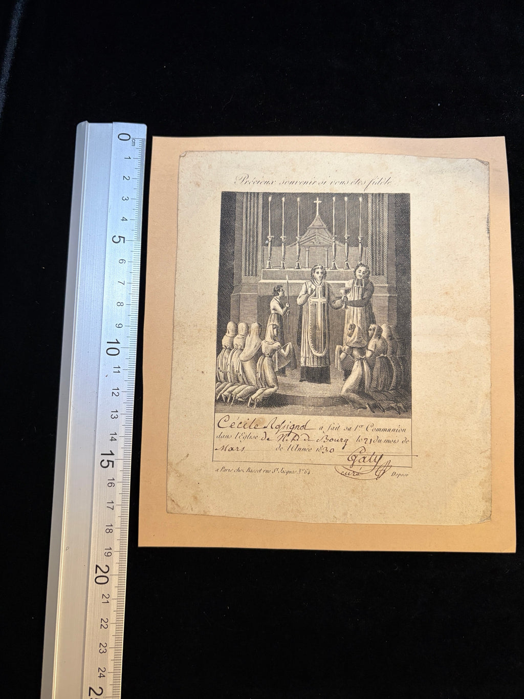 1830 First Communion certificate next to a ruler showing its size, about 15.5 x 18.5 cm on a card mount