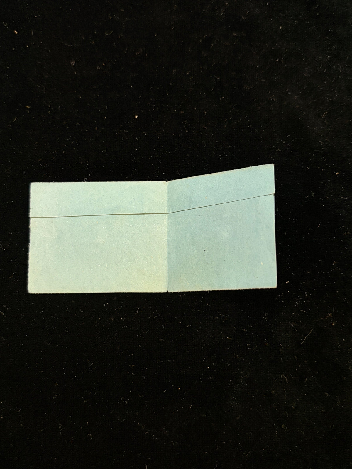 Anne Catherine Emmerich relic packet unfolded, showing the inside of the original paper wrapper