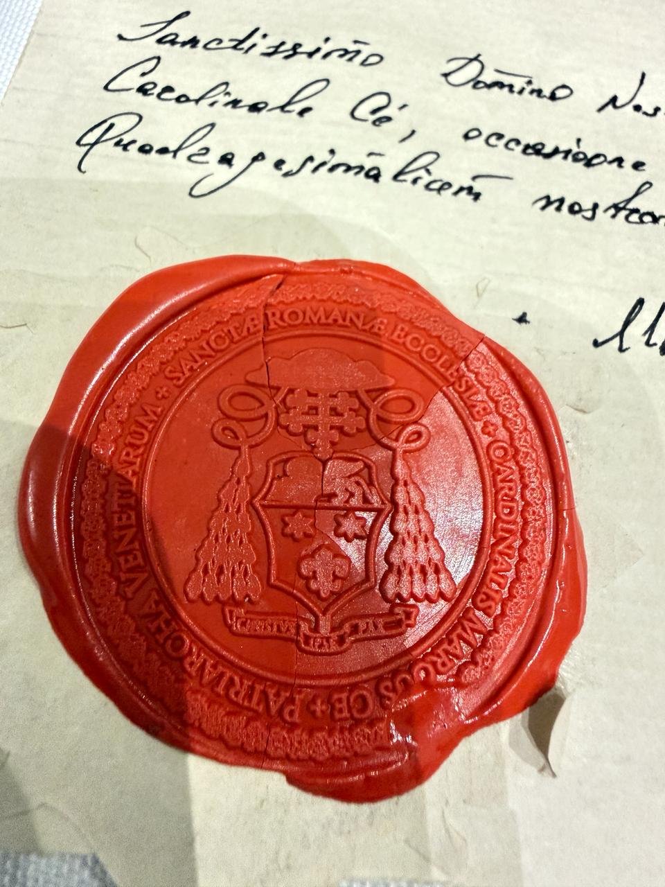 Close-up of the red wax ecclesiastical seal on the dedication accompanying the Holy Shroud of Turin linen reproduction