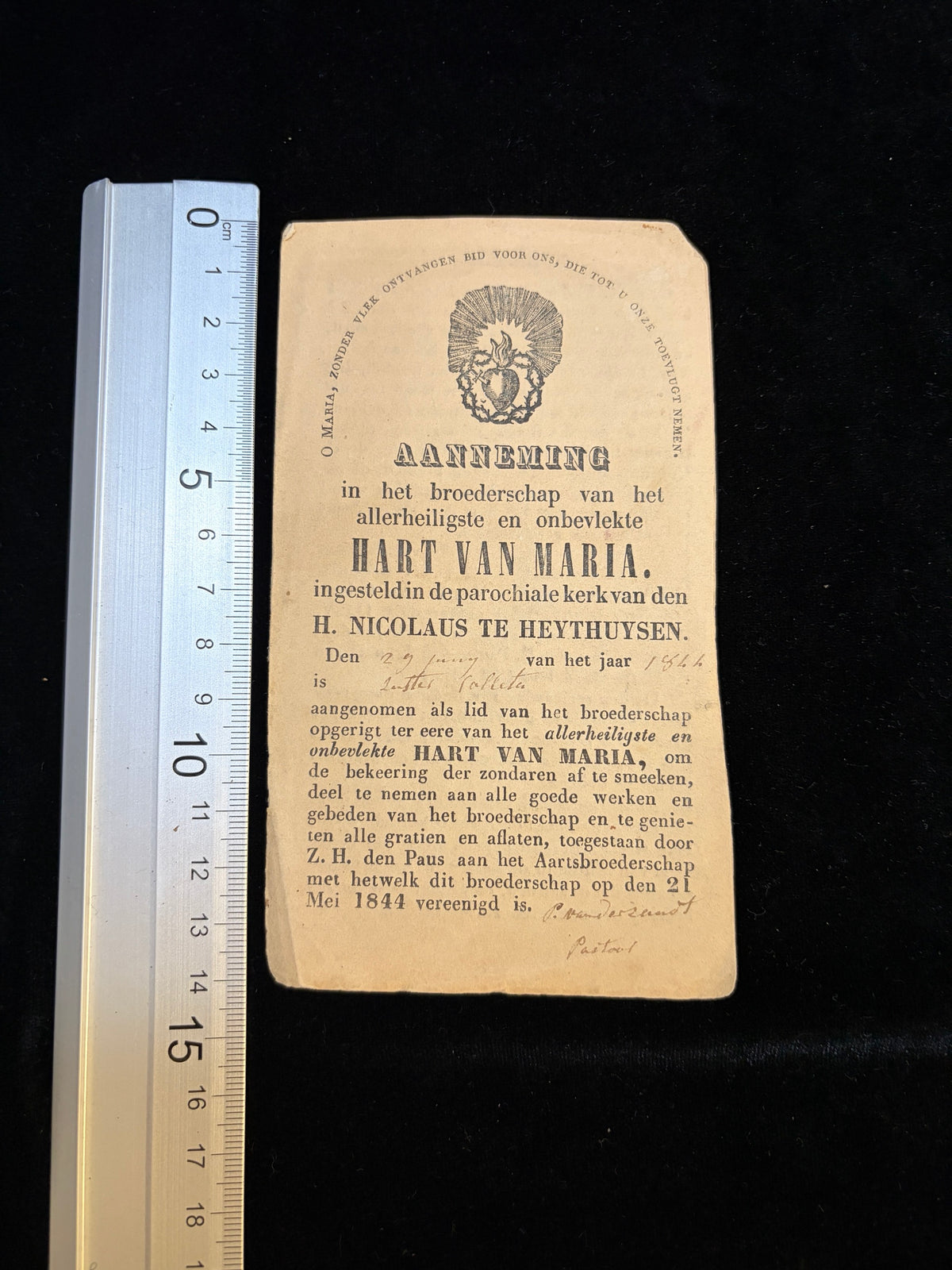 1840s confraternity certificate next to a ruler showing its size, about 8.7 x 14.4 cm