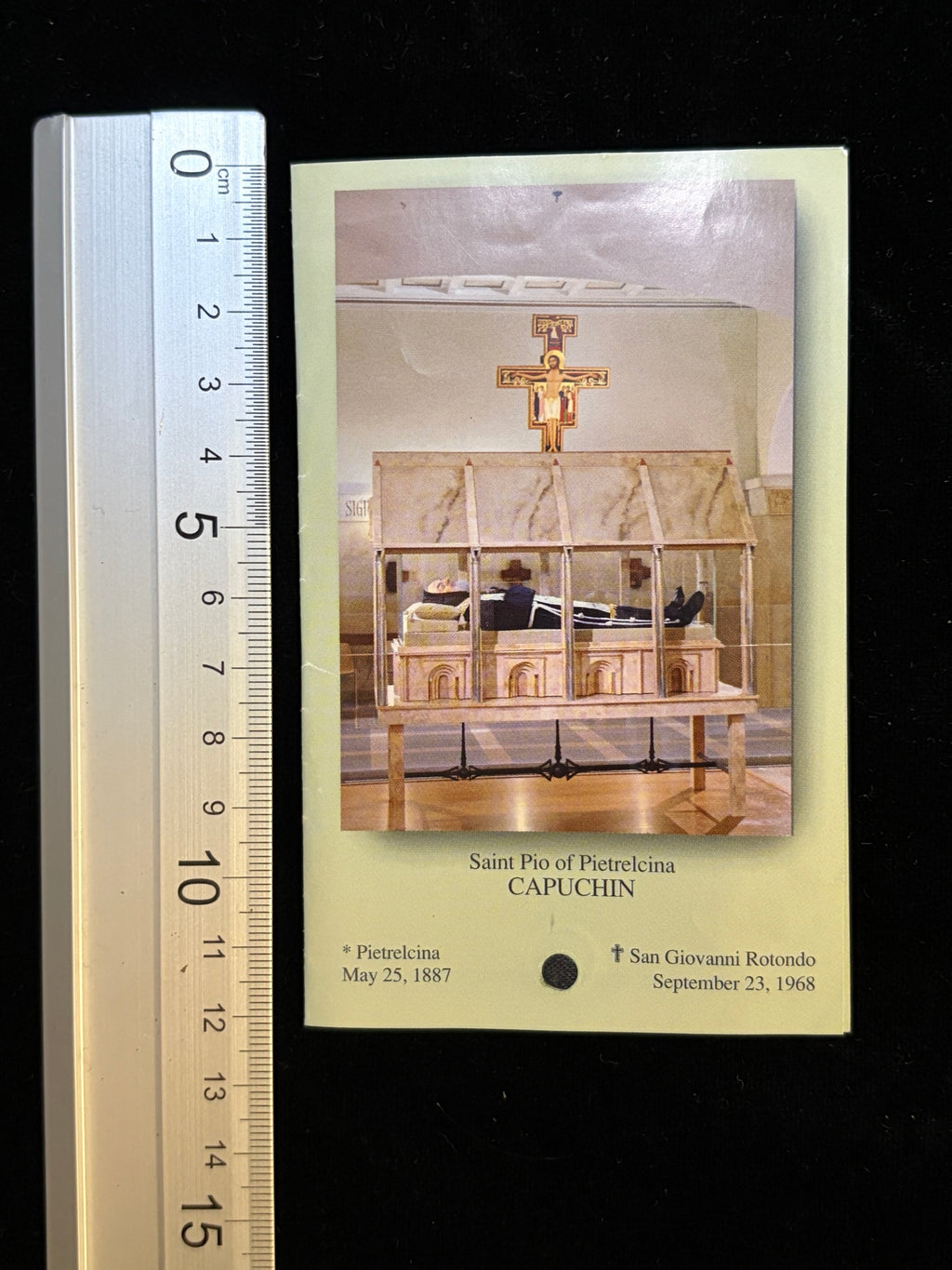 Padre Pio relic card next to a ruler showing its size, about 7.9 x 12.2 cm