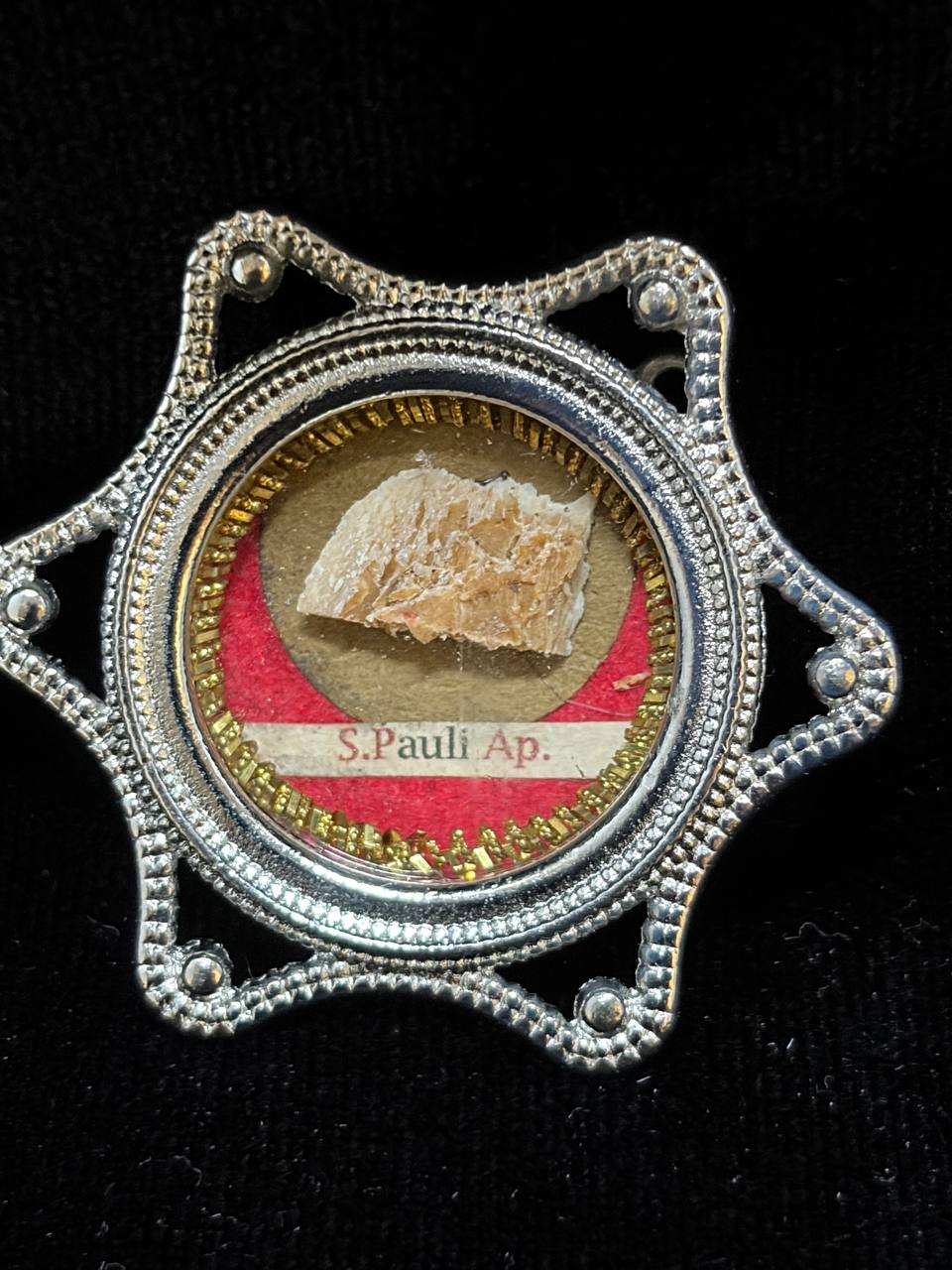 Saint Paul the Apostle relic in a silver star-shaped theca, label S. Pauli Ap., close-up of the relic
