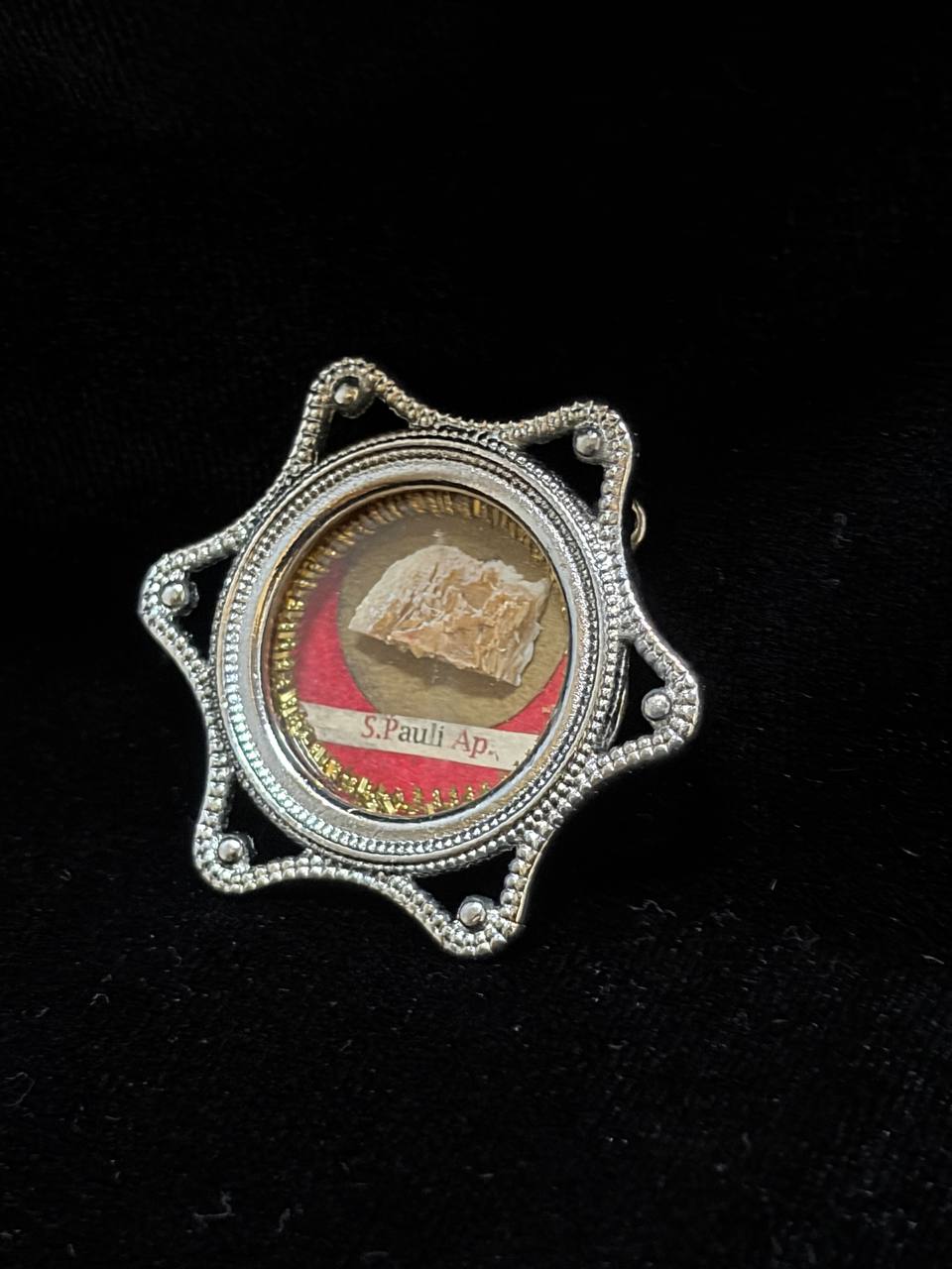 Saint Paul the Apostle relic in a silver star-shaped theca, label S. Pauli Ap., angled view