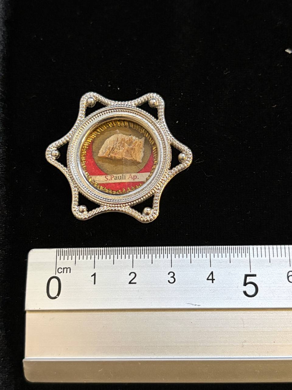 Saint Paul the Apostle relic star theca next to a ruler, about 4.5 cm across