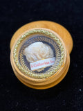 Saint Catherine of Siena relic in a round turned wooden theca with gilt rim, label S. Catharinae Sen., front view