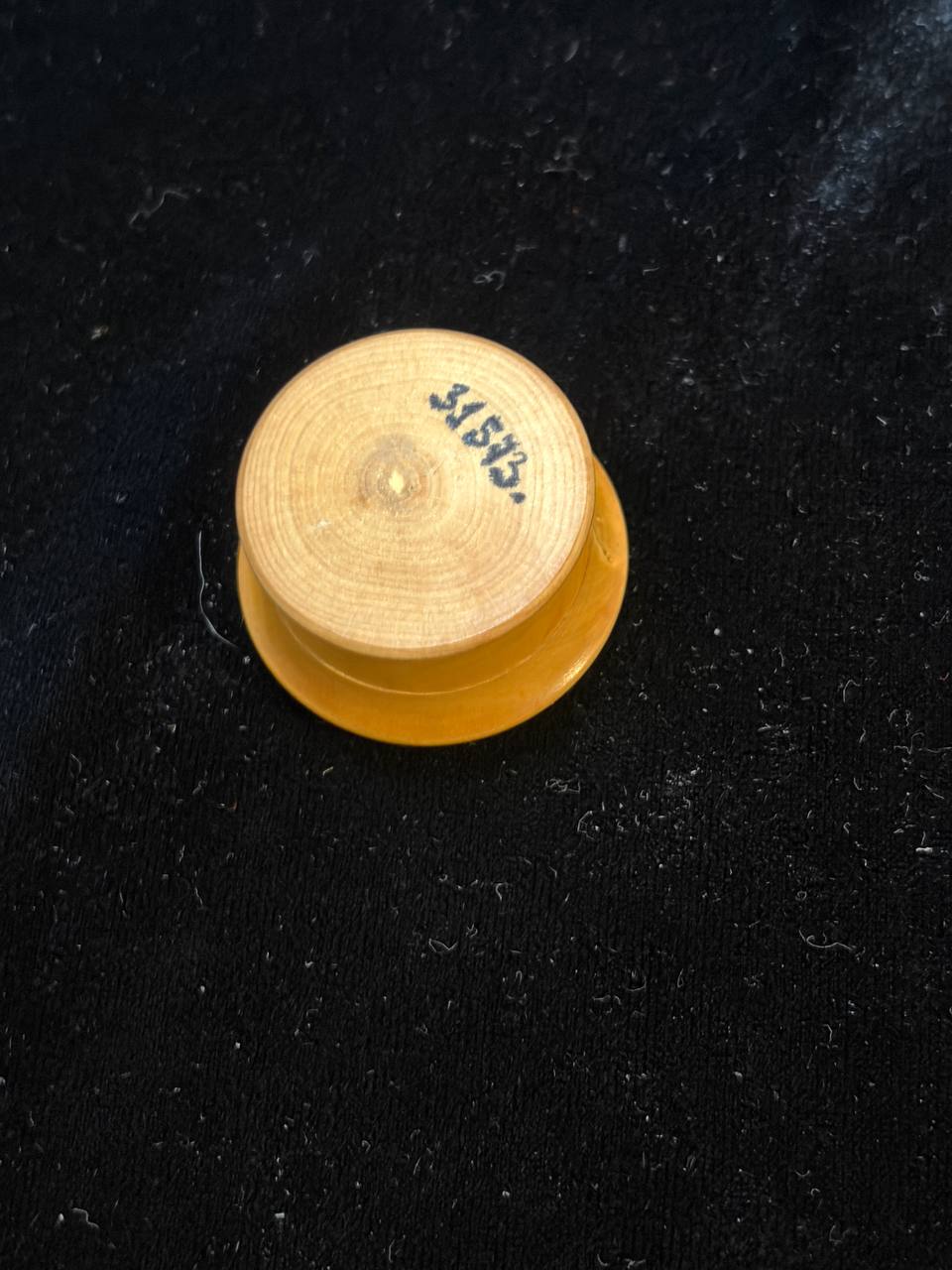 Back of the wooden theca with handwritten number