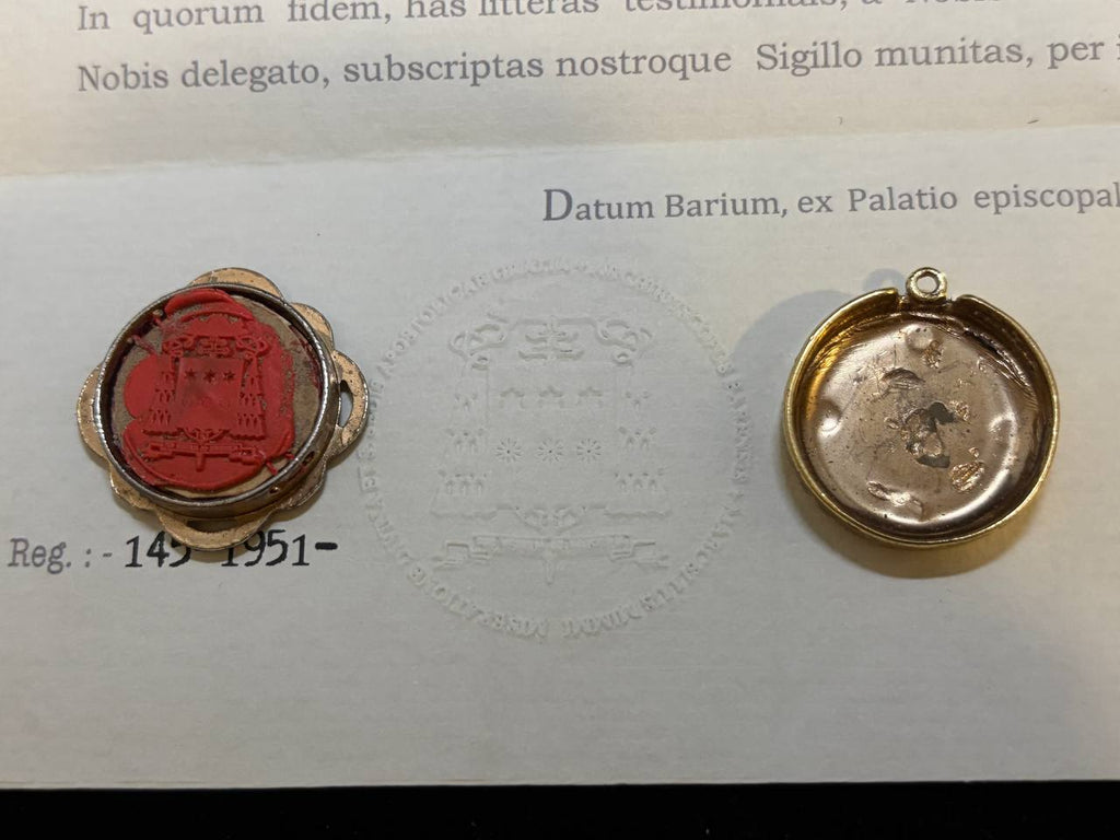 Red wax seal of Bari on the back of the Saint Nicholas theca, numbered 145-1951, beside the certificate