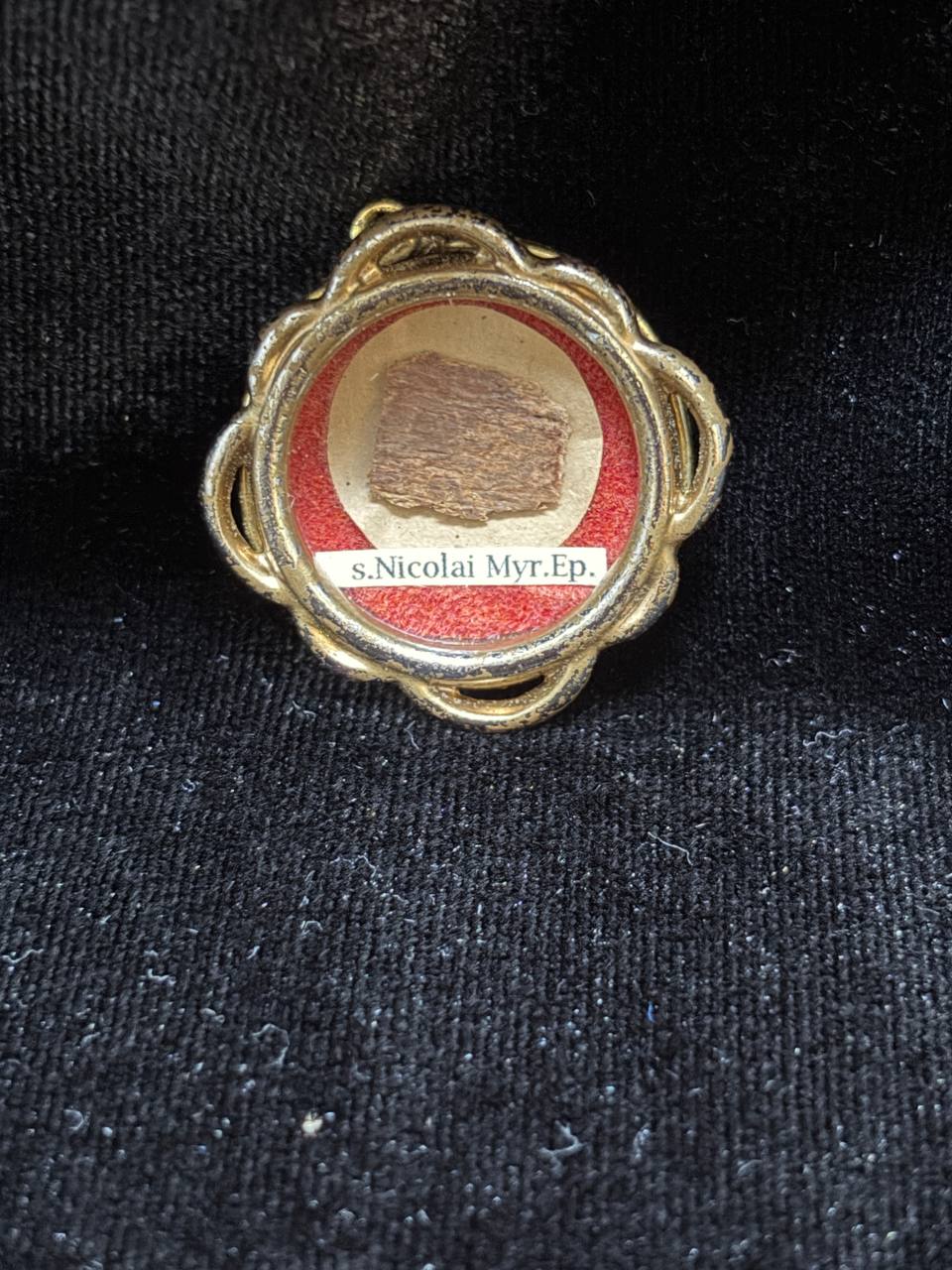 Saint Nicholas of Myra first-class relic in a gilt quatrefoil theca, label S. Nicolai Myr. Ep., on black velvet