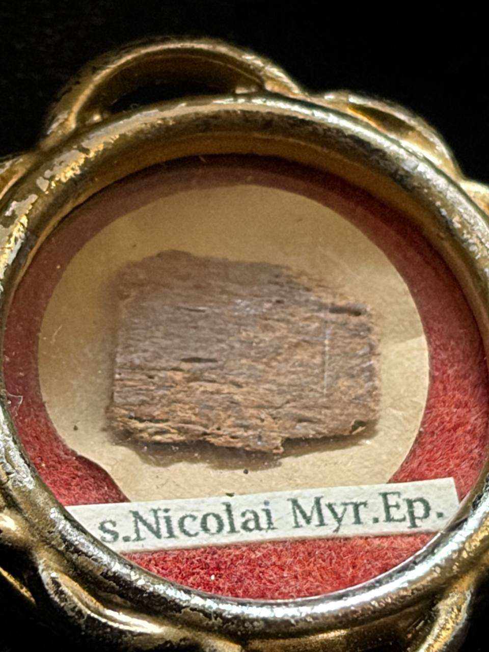 Saint Nicholas of Myra first-class relic in a gilt quatrefoil theca, label S. Nicolai Myr. Ep., close-up of the relic