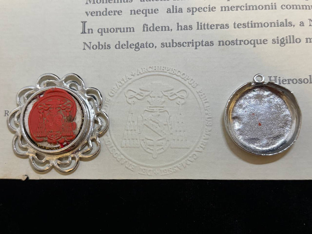 Red wax seal on the back of the Saint Pantaleon filigree theca beside the certificate