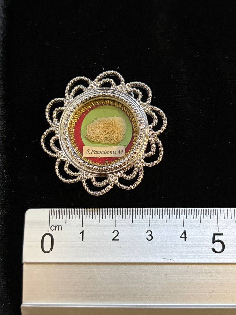 Saint Pantaleon relic filigree theca next to a ruler, about 4 cm across