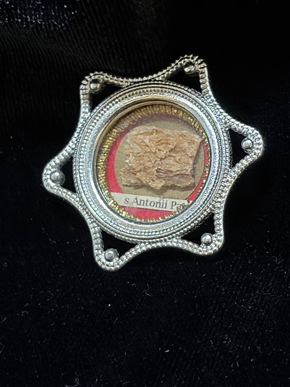 Saint Anthony of Padua relic in a silver star-shaped theca, label S. Antonii Pat., angled view