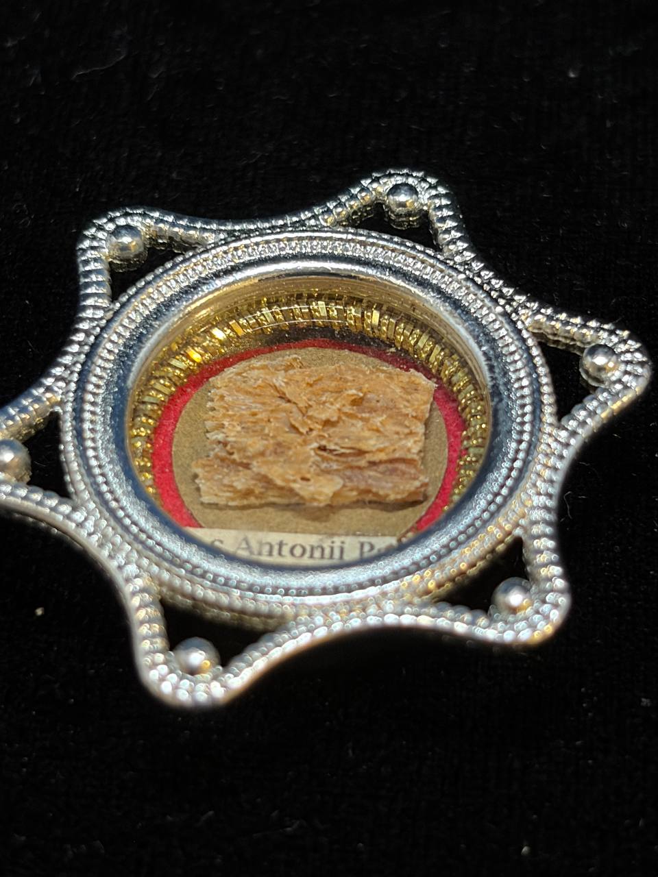 Saint Anthony of Padua relic in a silver star-shaped theca, label S. Antonii Pat., detail of the beaded frame