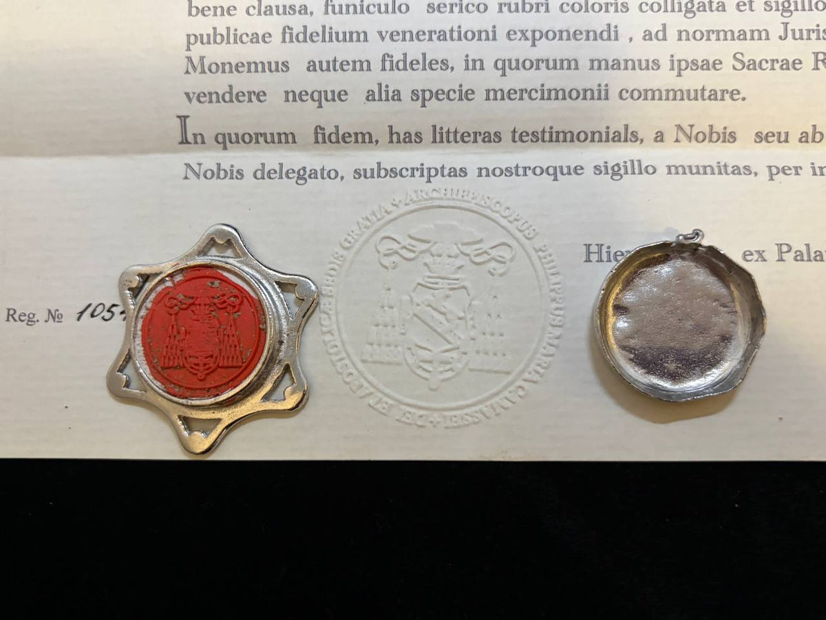 Red wax seal on the back of the Saint Mary Magdalene star theca beside the embossed certificate seal