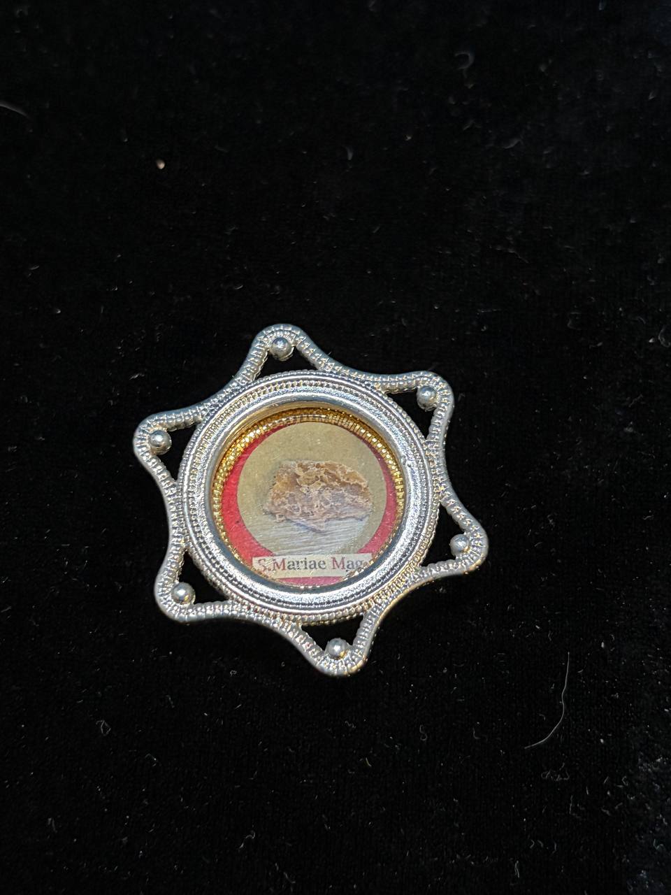 Saint Mary Magdalene relic in a silver star-shaped theca, label S. Mariae Magd., small on black velvet
