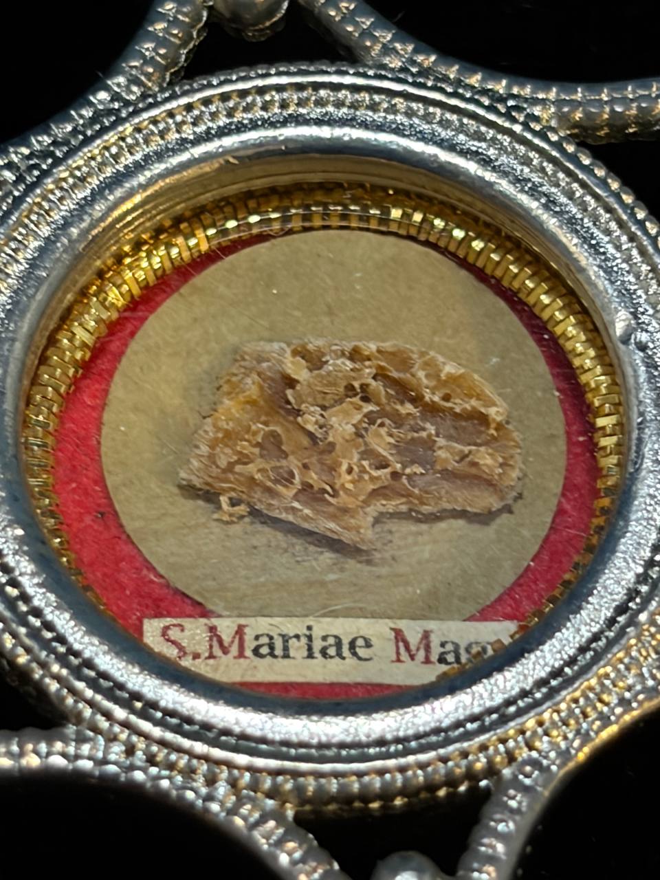 Saint Mary Magdalene relic in a silver star-shaped theca, label S. Mariae Magd., macro detail of the relic