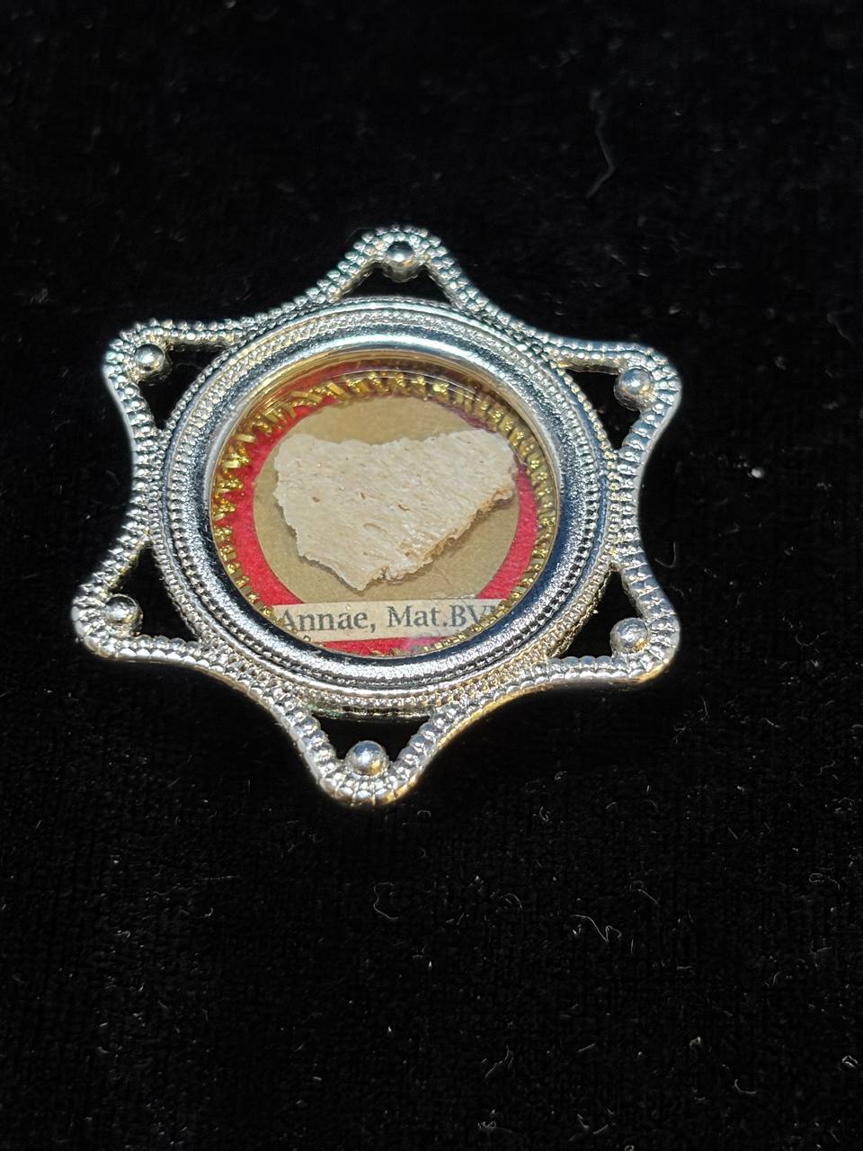 Saint Anne relic in a silver star-shaped theca, label S. Annae Mat. B.V.M., close-up