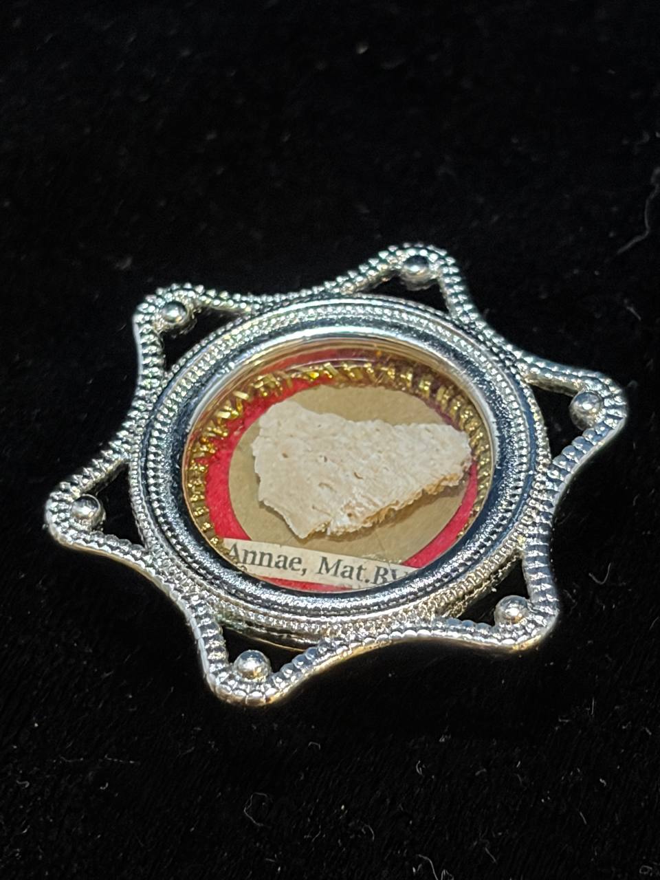 Saint Anne relic in a silver star-shaped theca, label S. Annae Mat. B.V.M., detail of the beaded frame