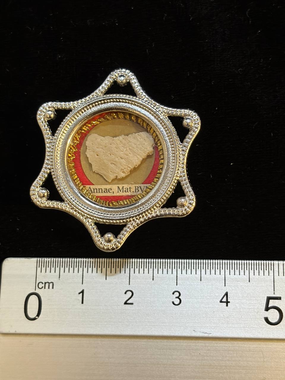 Saint Anne relic star theca next to a ruler, about 4.5 cm across