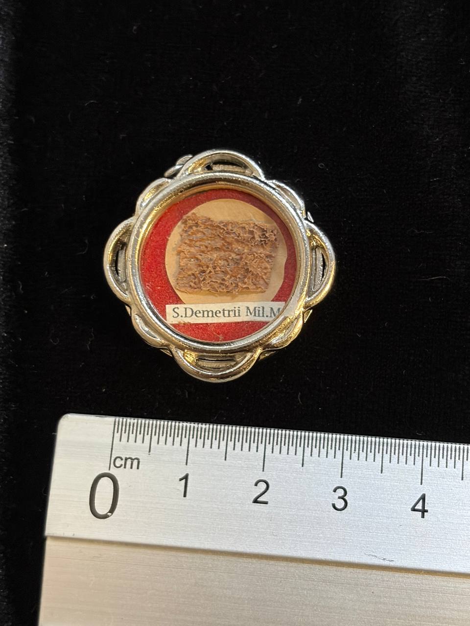 Saint Demetrius relic theca next to a ruler, about 3.5 cm across