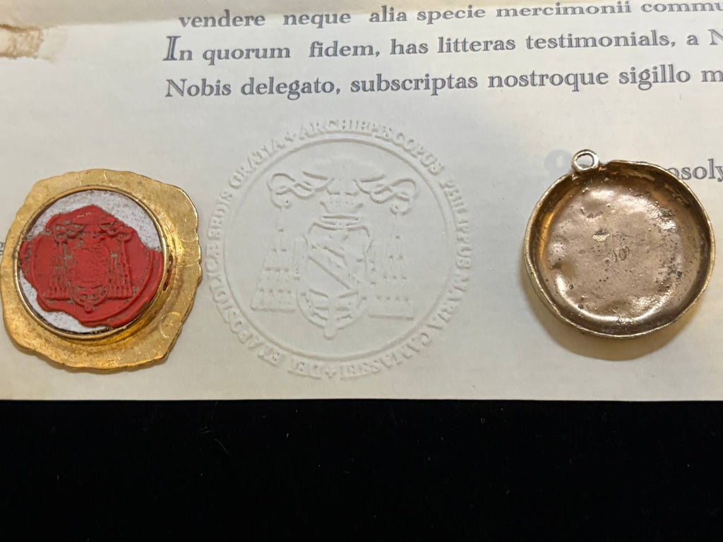Red wax seal of the Saint George relic beside the embossed certificate seal and the back of the gilt theca