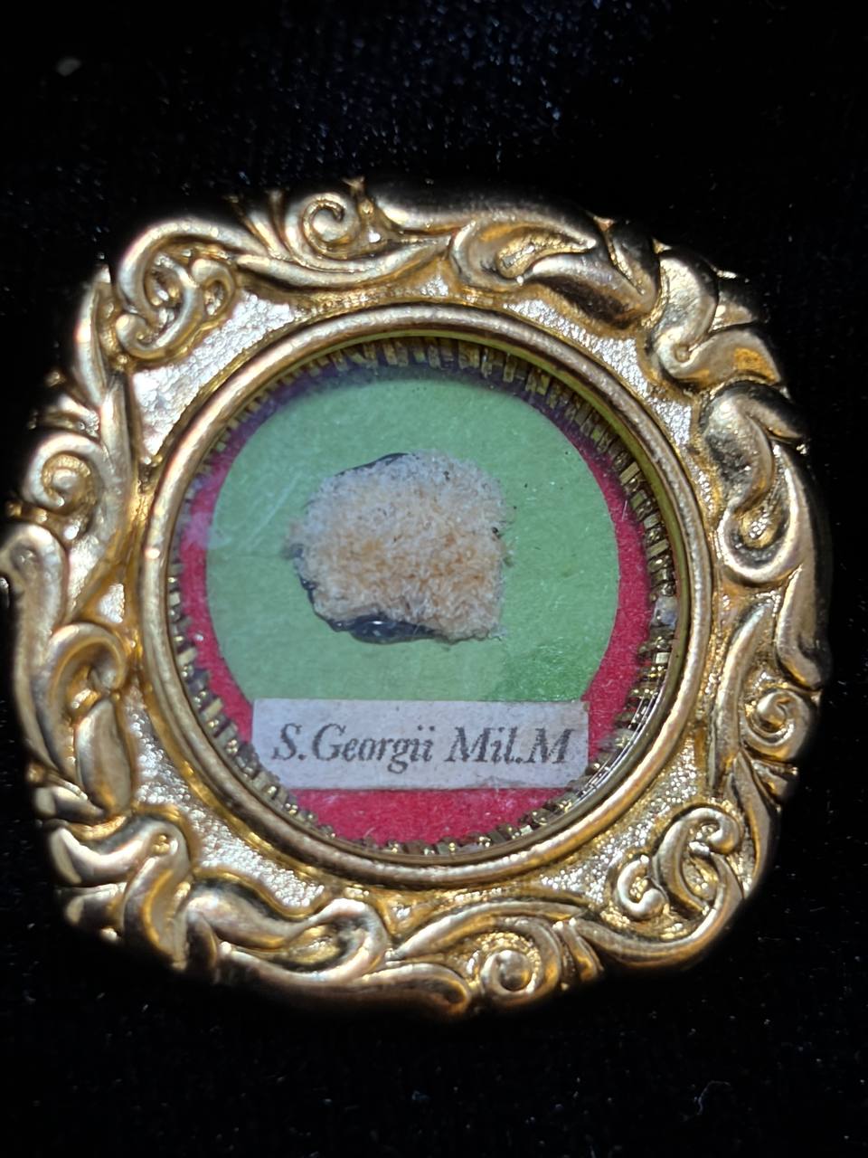 Saint George the Martyr relic in an ornate gilt scroll-frame theca, label S. Georgii M., front view