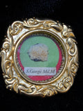 Saint George the Martyr relic in an ornate gilt scroll-frame theca, label S. Georgii M., front view