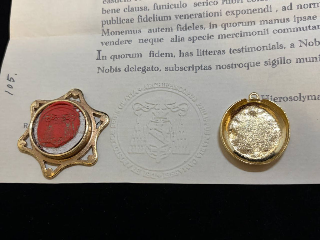 Red wax seal on the Saint Hermolaus certificate beside the back of the gilt theca