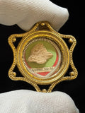 Saint Hermolaus of Nicomedia bone relic on green silk in a gilt star-shaped theca, held in a white glove
