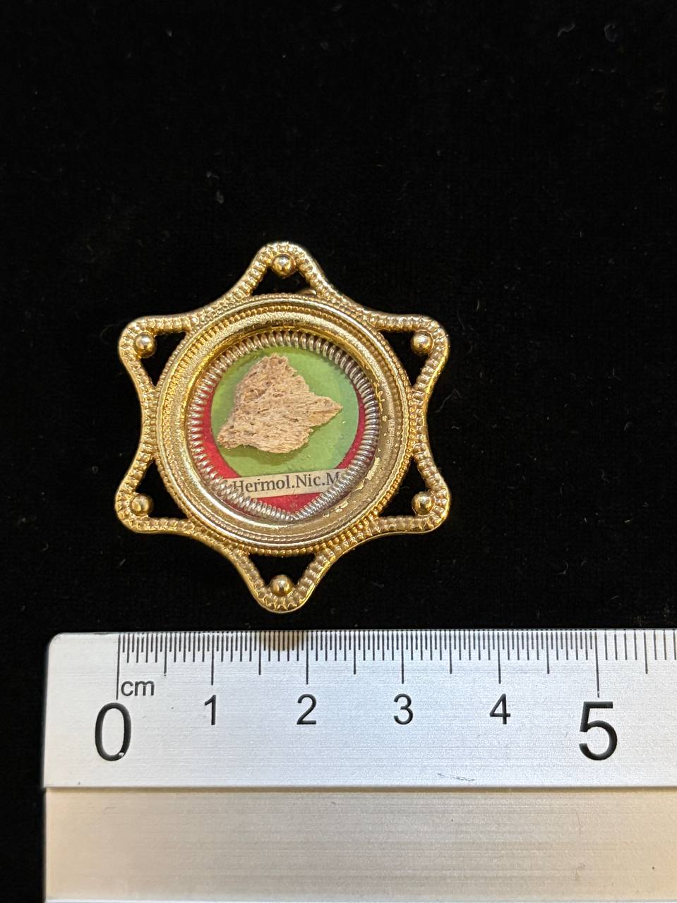 Saint Hermolaus relic theca next to a ruler, about 4 cm across