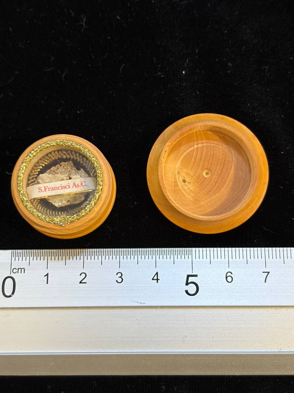 Saint Francis relic theca and lid next to a ruler, about 3 cm across