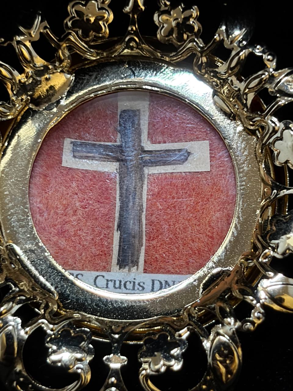 Close-up of the True Cross relic arranged as a cross on red silk