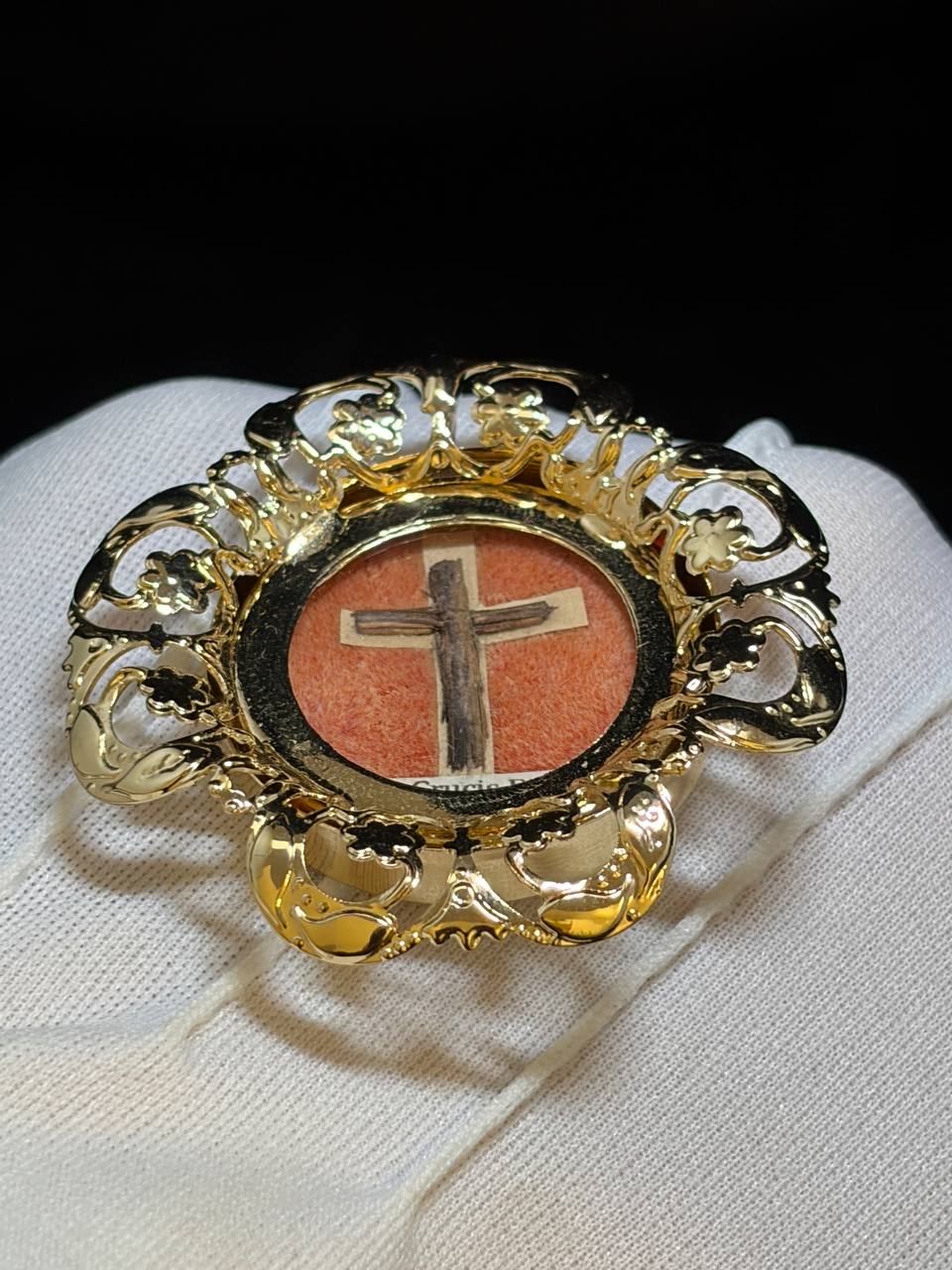 True Cross relic theca resting on a white glove