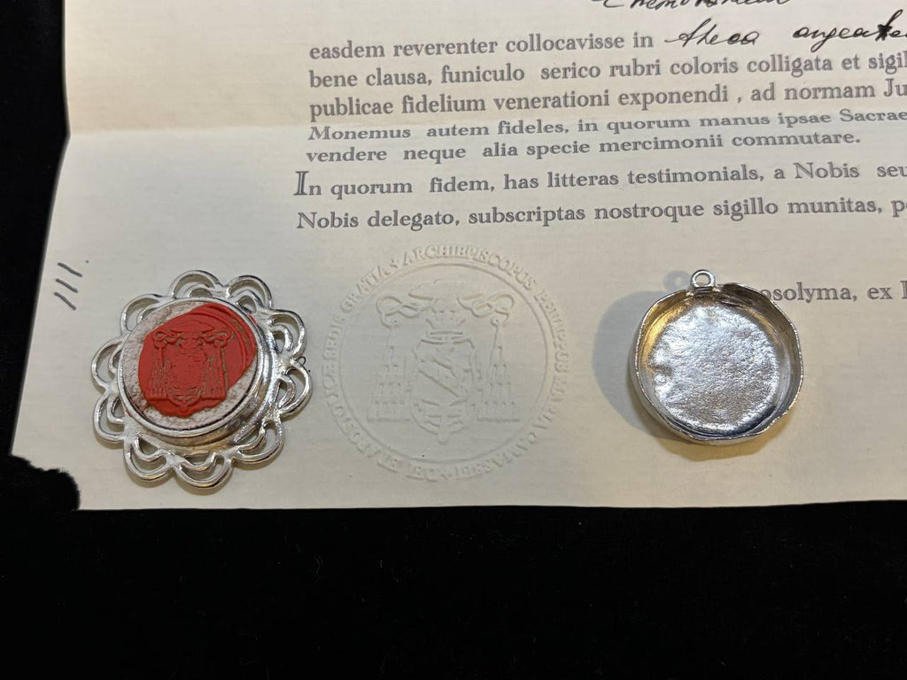 Red wax seal on the Saint Paul of Thebes certificate beside the back of the theca