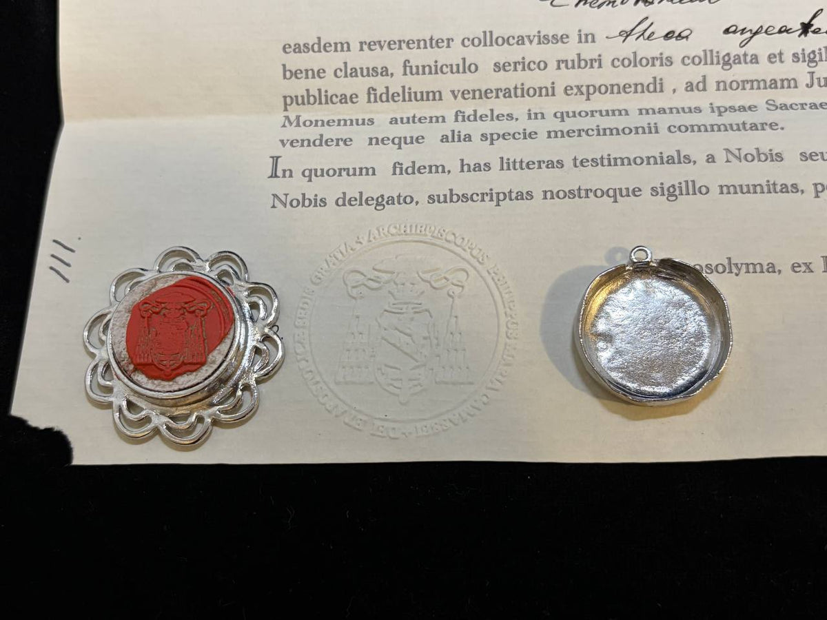 Red wax seal on the Saint Paul of Thebes certificate beside the back of the theca