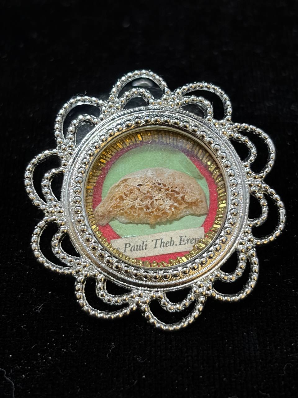 Saint Paul of Thebes relic in an ornate silver-tone filigree theca, label S. Pauli Theb. Erem.