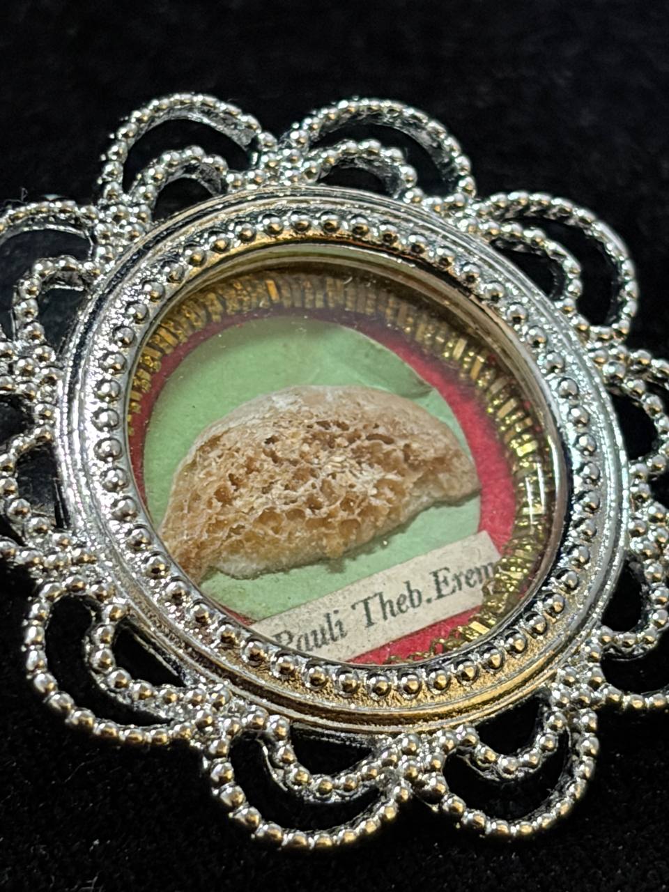 Close-up of the Saint Paul of Thebes relic fragment and label behind glass