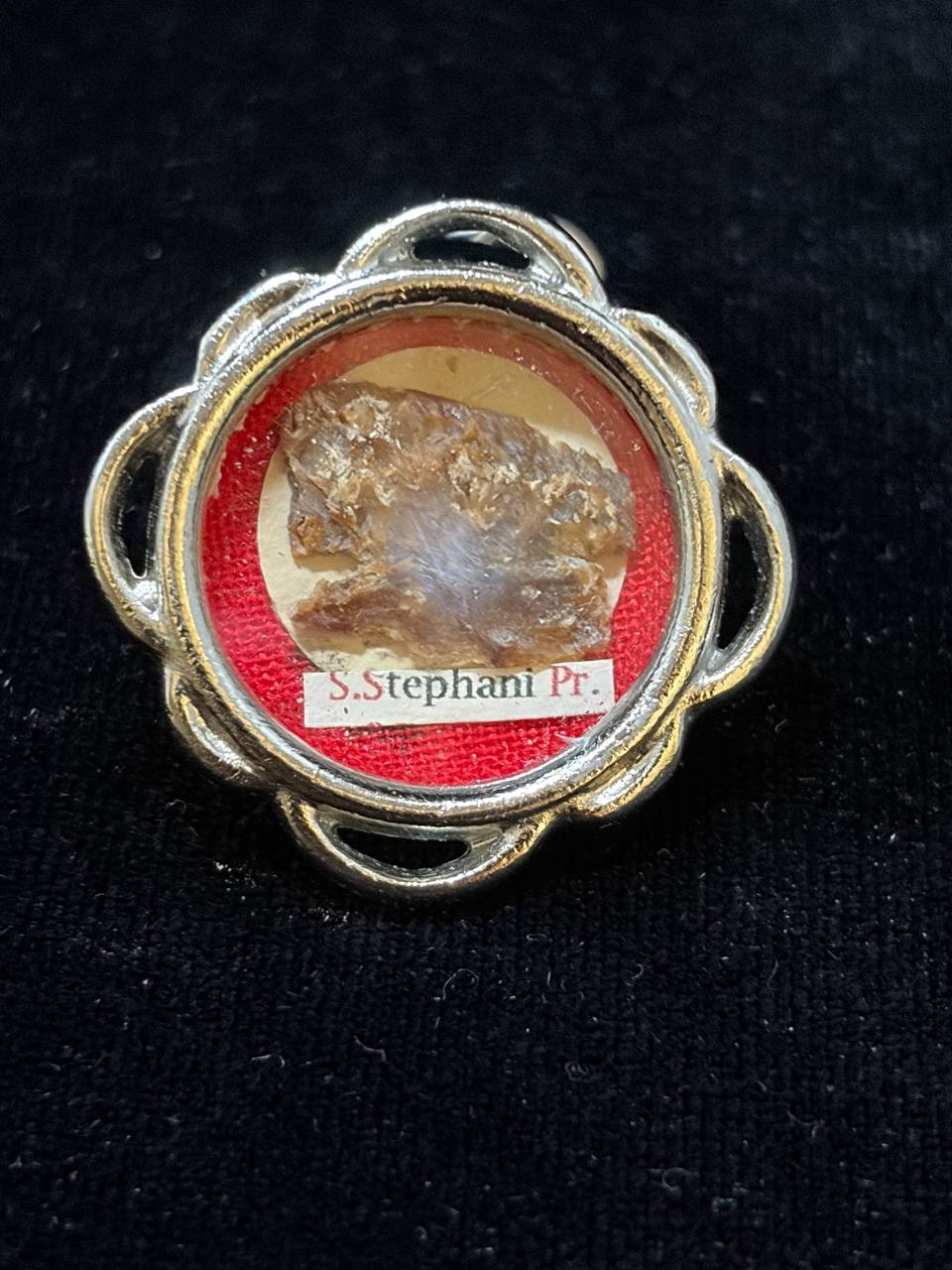 Silver-tone theca with relic of Saint Stephen the Protomartyr on red silk, label S. Stephani Pr.
