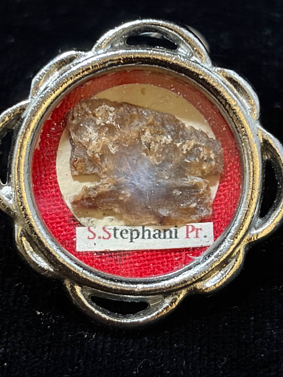 Close-up of the Saint Stephen relic fragment and label S. Stephani Pr. behind glass
