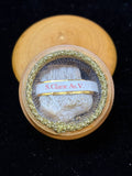 Saint Clare of Assisi relic in a round wooden theca with gilt trim and label S. Clarae As. V.