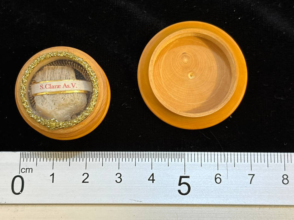 Saint Clare of Assisi relic theca next to a ruler, about 3 cm across