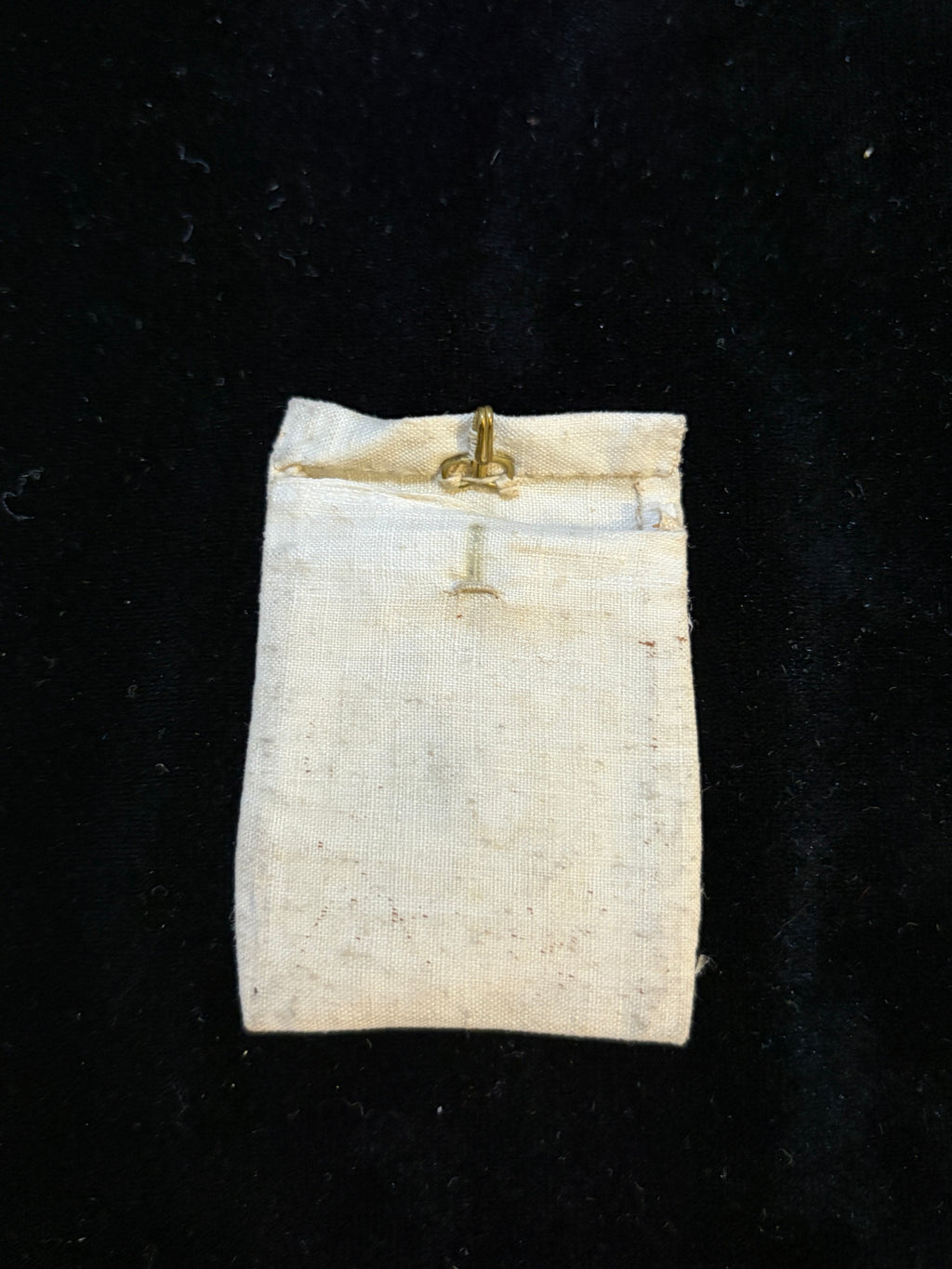 Hand-sewn ivory linen relic bursa with brass hook, front view
